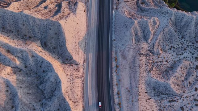 Aerial Desert View looking down on Needles Hwy near Laughlin Nevada. This early morning shot of the lonely desert Hwy reveals an interesting view of the road cutting through the Mojave Desert.
