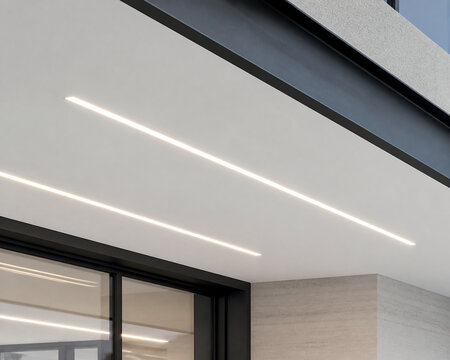 Modern building soffit with recessed linear LED strips in white ceiling.