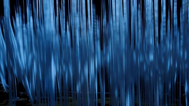 Flowing blue water streams create a mesmerizing visual effect, showcasing the dynamic movement of water droplets against a dark background in a natural setting