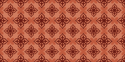 Classic damask style pattern displays intricate dark mahogany fleur de lis motifs on terra cotta orange background for luxury fabric printing. © The Artist