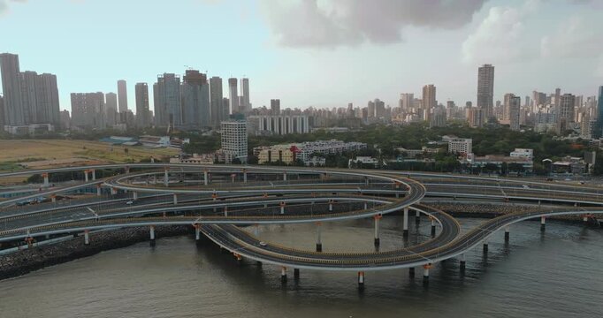 Morning view of the Mumbai Coastal Road in Maharashtra, India, famously known as the 'City of Dreams.' The scene captures a multi-level interchange roadway. A complex road network and urban designs.