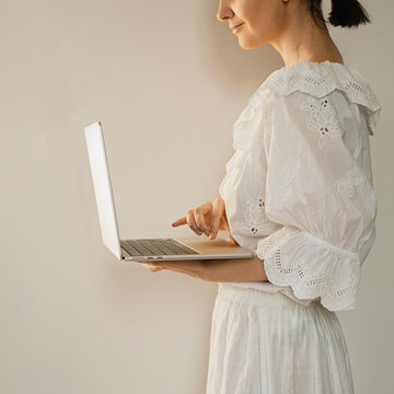 Cropped View Of Woman In Cottagecore Style Using Silver Laptop