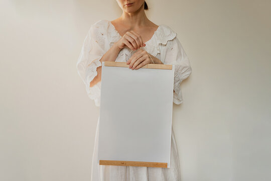 Woman In White Embroidered Vintage Blouse Holding Blank Poster Mockup