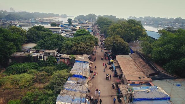 Aerial view of Sewri village near the Dockyard area in Mumbai, India, capturing a striking contrast between traditional coastal settlements and industrial port infrastructure.