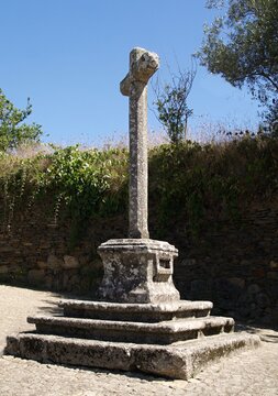 Ancient stone Calvary cross standing in the rural Portuguese village of Quintadona, Portugal - Norte