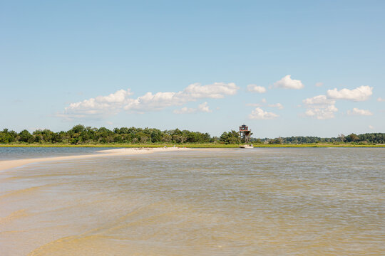 Modern stilt house on a sunny coastal sandbar