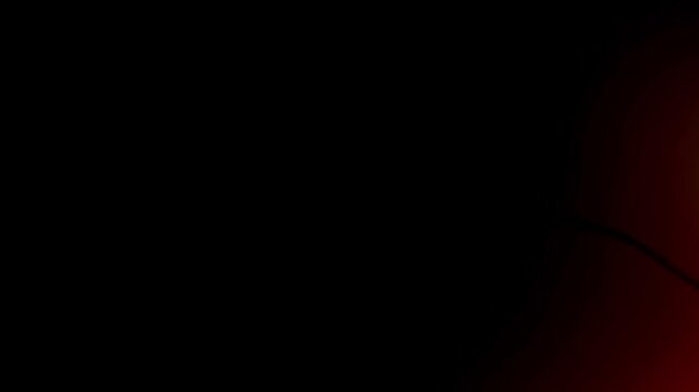 film burn effect with a glowing red light emerging from darkness. This footage is ideal for transitions or adding a dramatic element.