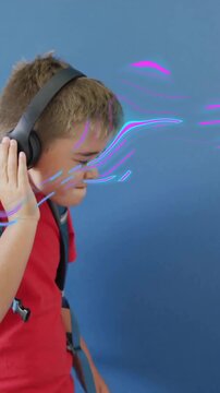 Animation of purple shapes moving over caucasian schoolboy listening to music