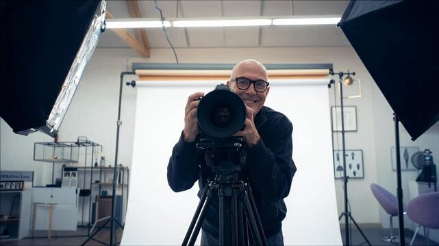 Photographer operating professional camera equipment in a studio setting