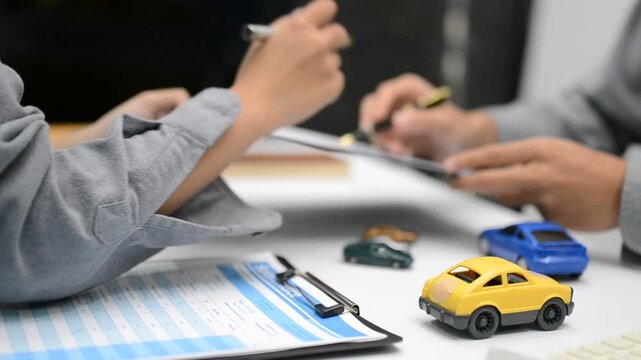 Woman signing auto insurance contract with agent after car crash claim. Trustworthy vehicle protection, policy coverage, and financial deal.