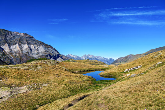 Hiking trail in Cirque de Troumouse at Heas in the Hautes-Pyrenees department in France, forming the border with Spain