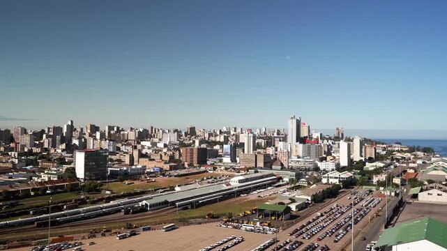 Panoramic view of Maputo, Mozambique, showing the city skyline, railway area, and coastal horizon under a clear blue sky.