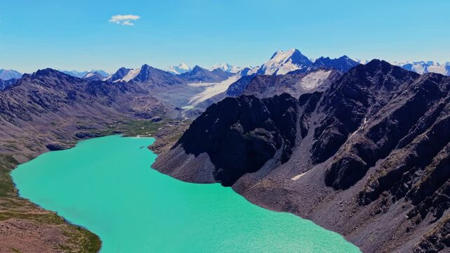 High altitude drone flying above mountain peaks in Kyrgyzstan Ala Kul region