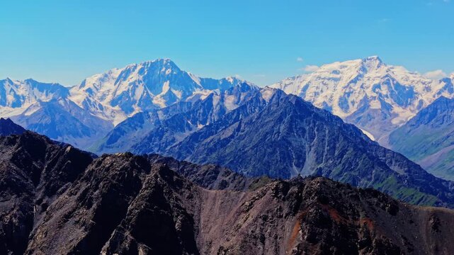 Drone view of snow capped peaks in Kyrgyzstan's Ala-Kul region