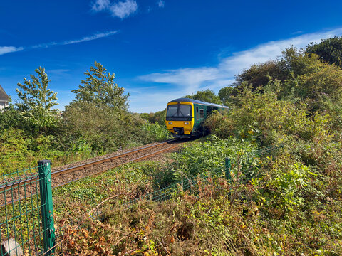 Green Great Western Railway Passenger Train Approaching Along Railway Line in Exmouth, Devon