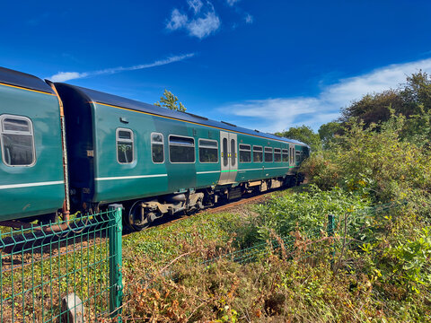Great Western Railway Train Traveling Through Countryside in Exmouth, Devon Under Blue Sky