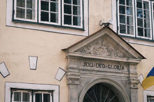 Close-up of the sculpted stone portal entrance bearing Soli Deo Gloria inscription on the Three Brothers building in Riga Old Town, Latvia.