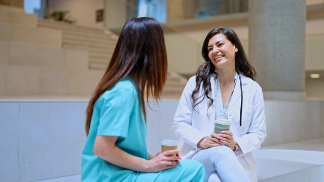 Healthcare professionals smiling and talking during a coffee break