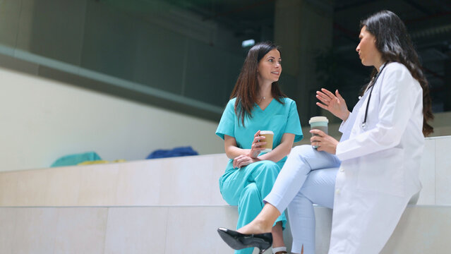 Doctors and nurses discussing healthcare during a coffee break
