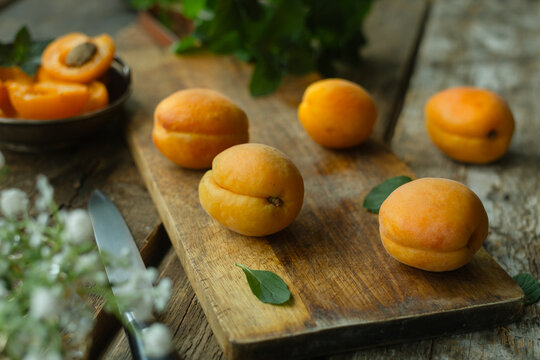 Fresh apricots on wooden table. Summer seasonal fruits.