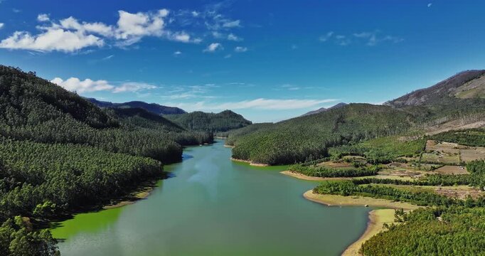 Aerial view of Munnar, Kerala, featuring Mattupetty Dam, Eco Point, and Kundala Lake. The footage captures the lush green tea plantations, rolling hills, and serene water bodies from above.