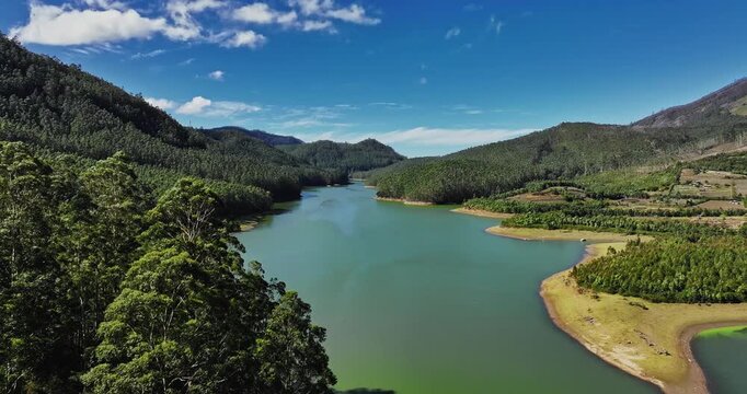 Aerial view of Munnar, Kerala, featuring Mattupetty Dam, Eco Point, and Kundala Lake. The footage captures the lush green tea plantations, rolling hills, and serene water bodies from above.