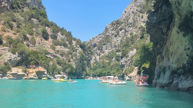 Gorges du Verdon Adventure Stunning boats sailing in clear blue waters. Sunlit cliffs tower above. Enjoy breathtaking views from every angle. Perfect for getaway lovers.