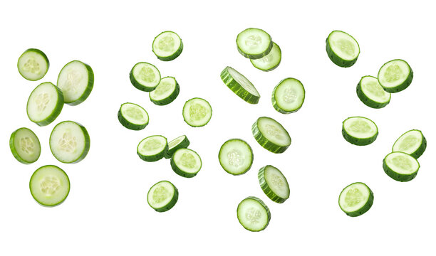 Dynamic arrangement of fresh green cucumber slices, many suspended in motion, on a transparent background.