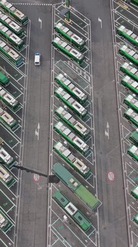 Aerial view of electric buses parked at charging stations in San Donato Milanese, Milan, Italy, illustrating modern public transport and clean energy infrastructure.