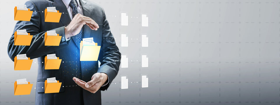 Businessman holding a virtual folder representing digital document management, cloud storage, database organization, and secure data archiving systems. Data organization and file management concept