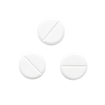 Three white pills with dividing line on a clean surface
