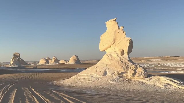 Moving through white desert landscape with rock formations and tire tracks Egypt