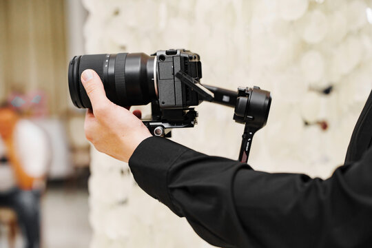 Videographer Adjusting Lens Ring on Camera Gimbal Rig