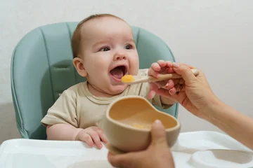 Toddler eats baby food © olgasparrow