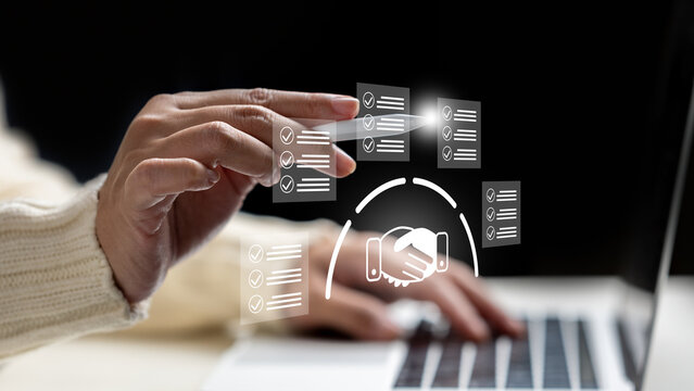 Close-up of female hands using a laptop and stylus with digital checklist and handshake icons, representing digital contract agreement and compliance. Management concept