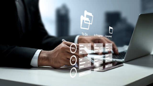 Businessman managing workflows on a digital tablet with virtual task management, to-do list, and progress tracking graphics. Management concept