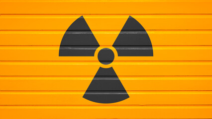 Black radiation warning symbol painted on a bright yellow metal shutter background. Nuclear concept © Leo Lintang