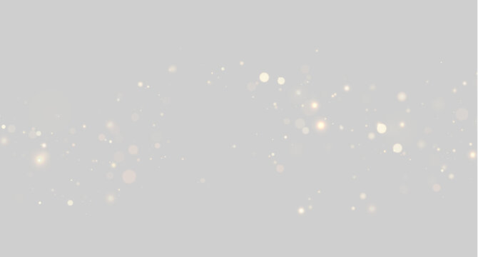 Soft horizontal band of scattered glowing warm light particles on transparent background