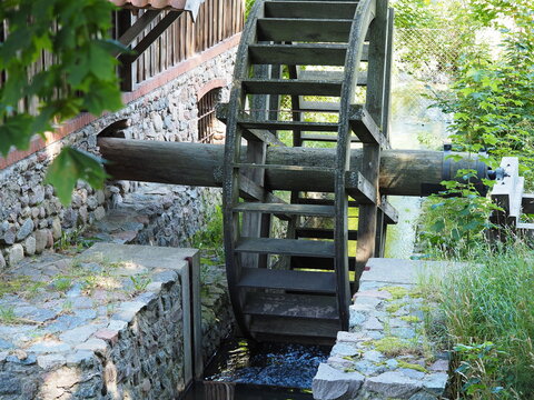 Wooden mill wheel by the stream