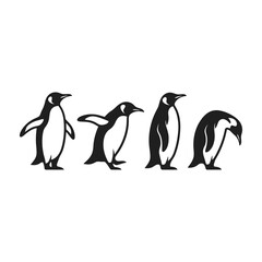 Fototapeta premium Four penguins standing in a row looking around curiously outdoors