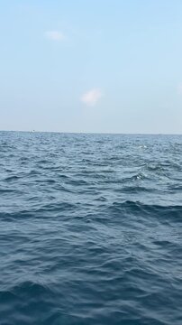 Peaceful blue sea waves under clear daylight sky ocean background