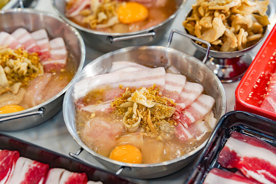 Thai Pork BBQ Buffet (Mu Kratha) &ndash; Delicious grilled sliced pork and fresh vegetables on a traditional dome skillet. Perfect for street food, Asian cuisine, and dining background graphics.