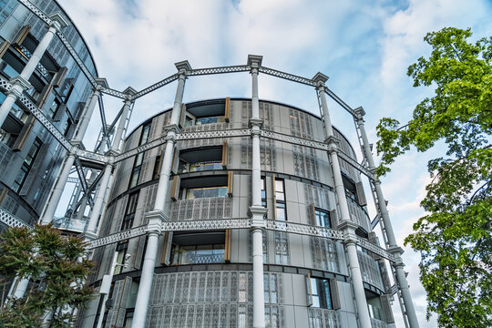 View of the Gasholder Park apartments, a unique residential building featuring a historic circular metal framework in London, England, United Kingdom.