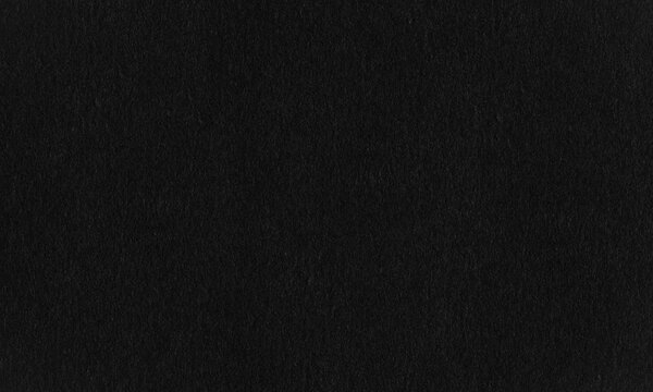 Dark black paper texture background with fine grain and matte finish for creative design projects Background