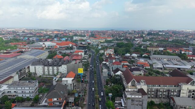 Aerial view of the Statue of Dewa Ruci at the intersection in the urban landscape of Kecamatan Kuta, Bali, Indonesia.