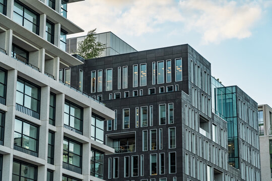 View of modern office buildings with glass facades and dark stone cladding near King's Cross St. Pancras in London, England, United Kingdom.