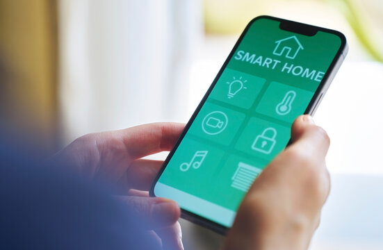 Woman controls smart home system using mobile app indoors