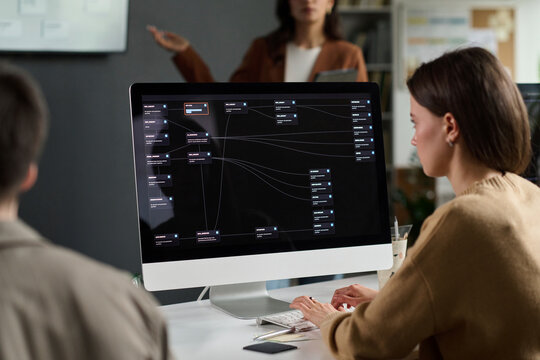 Female student programming on computer during university class