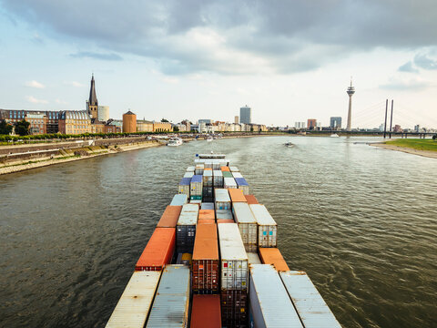 Germany, Duesseldorf, cargo ship transporting containers at Rhine River