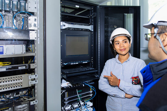 Engineer and technician check control box at wind farm
